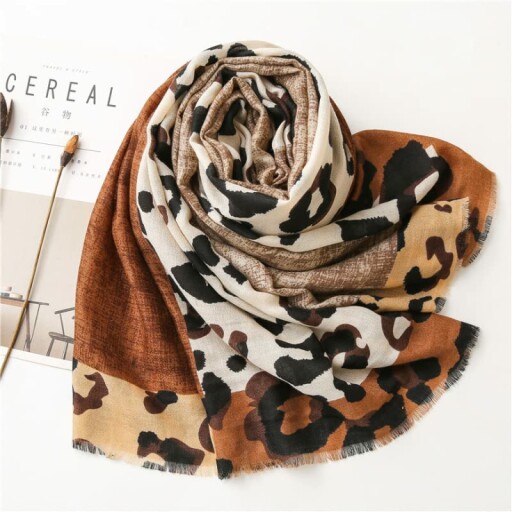 Leopard print scarf styled on a model wearing casual attire.