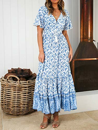 Woman in a blue floral maxi dress standing indoors.