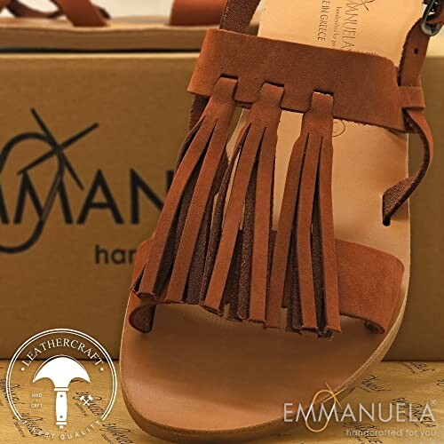 Brown leather sandal with fringes and Emmanuela branding.