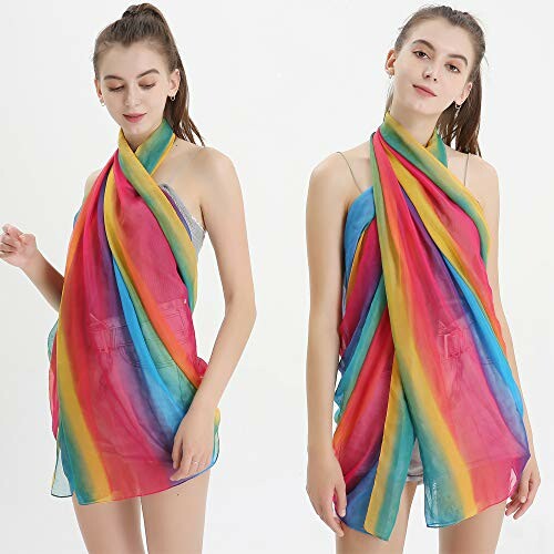 Two women wearing rainbow-colored beach cover-ups.