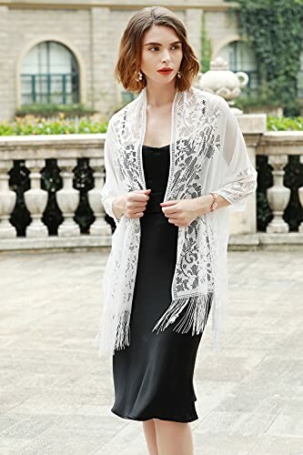Woman in black dress with white lace shawl standing outdoors