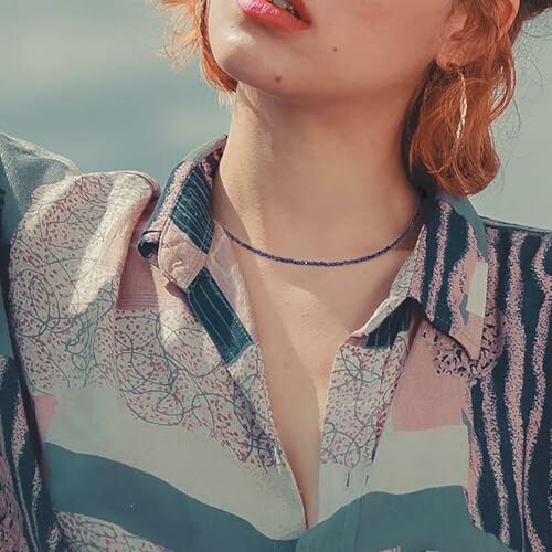 Woman in patterned shirt with short hair