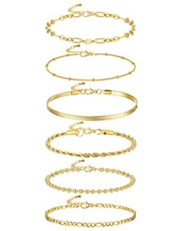 Set of seven gold bracelets with various designs.