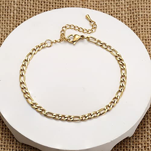 Gold chain bracelet on display stand