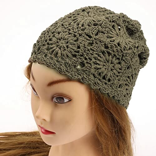 Mannequin wearing a green knit floral beanie