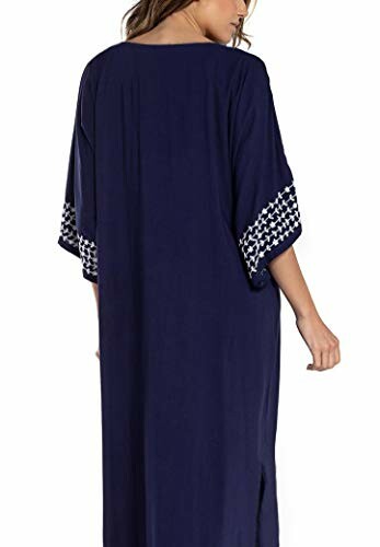 Back view of a woman wearing a navy blue kaftan with patterned sleeves.