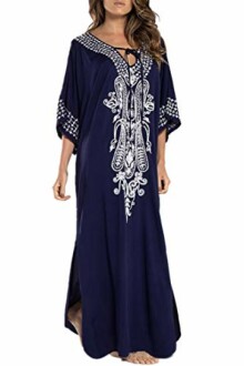 Woman wearing navy blue kaftan dress with white embroidery