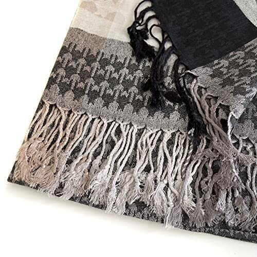 Close-up of a patterned scarf with fringe detailing.