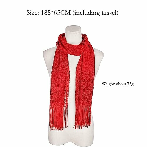 Red scarf with tassels displayed on a mannequin.