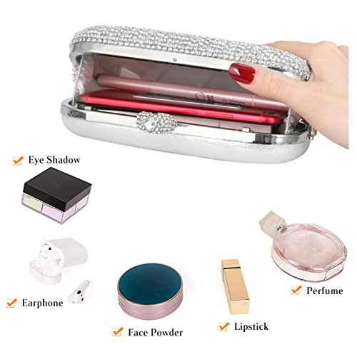 Silver clutch bag with makeup and accessories, including lipstick and earphones.