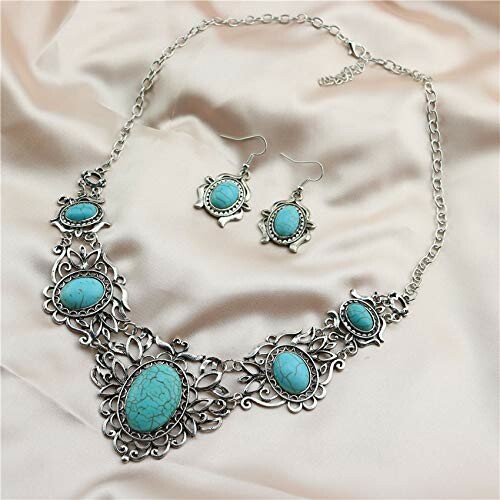 Turquoise and silver necklace with matching earrings on fabric