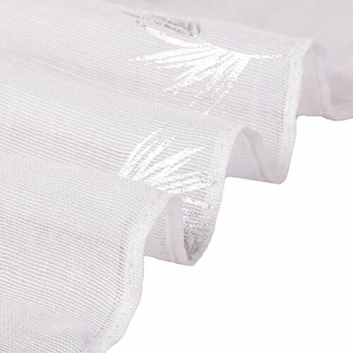 Close-up of white sheer fabric with silver palm leaves