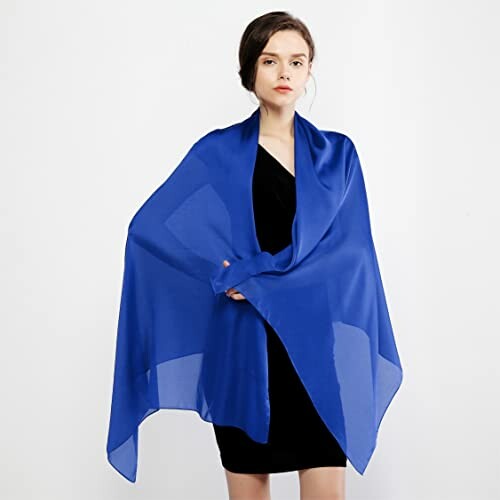 Woman wearing a blue chiffon wrap over a black dress