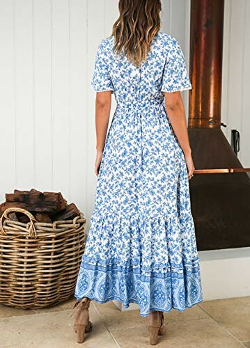 Woman wearing a blue floral dress standing indoors near a wicker basket.