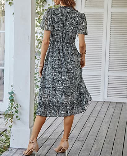 Woman in a floral dress standing on a porch