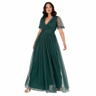 Woman wearing a green evening gown with sheer sleeves.