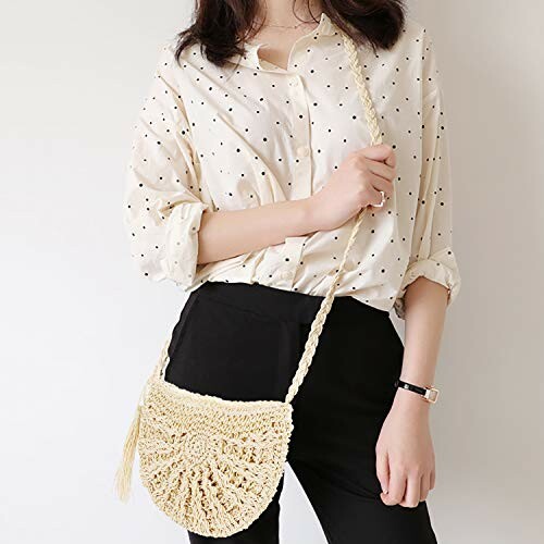 Woman in polka dot shirt holding a woven bag