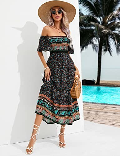Woman in a floral off-shoulder dress and sun hat standing by a pool.