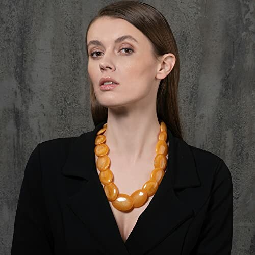 Woman in black outfit with amber necklace
