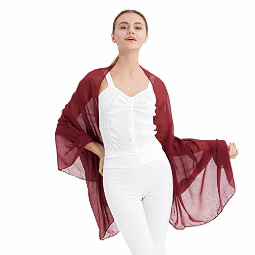 Woman wearing a burgundy shawl over a white outfit.