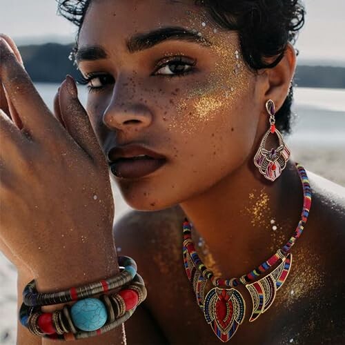 Woman wearing colorful jewelry with glitter on her face.